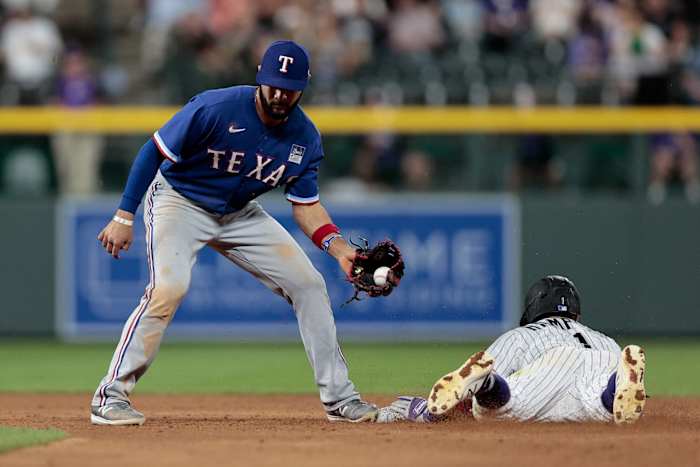 Jun 2, 2021; Denver, Colorado, USA; Colorado Rockies shortstop Garrett Hampson (1) steals second against Texas Rangers shortstop Isiah Kiner-Falefa (9) in the eighth inning at Coors Field.